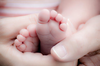 holding baby feet